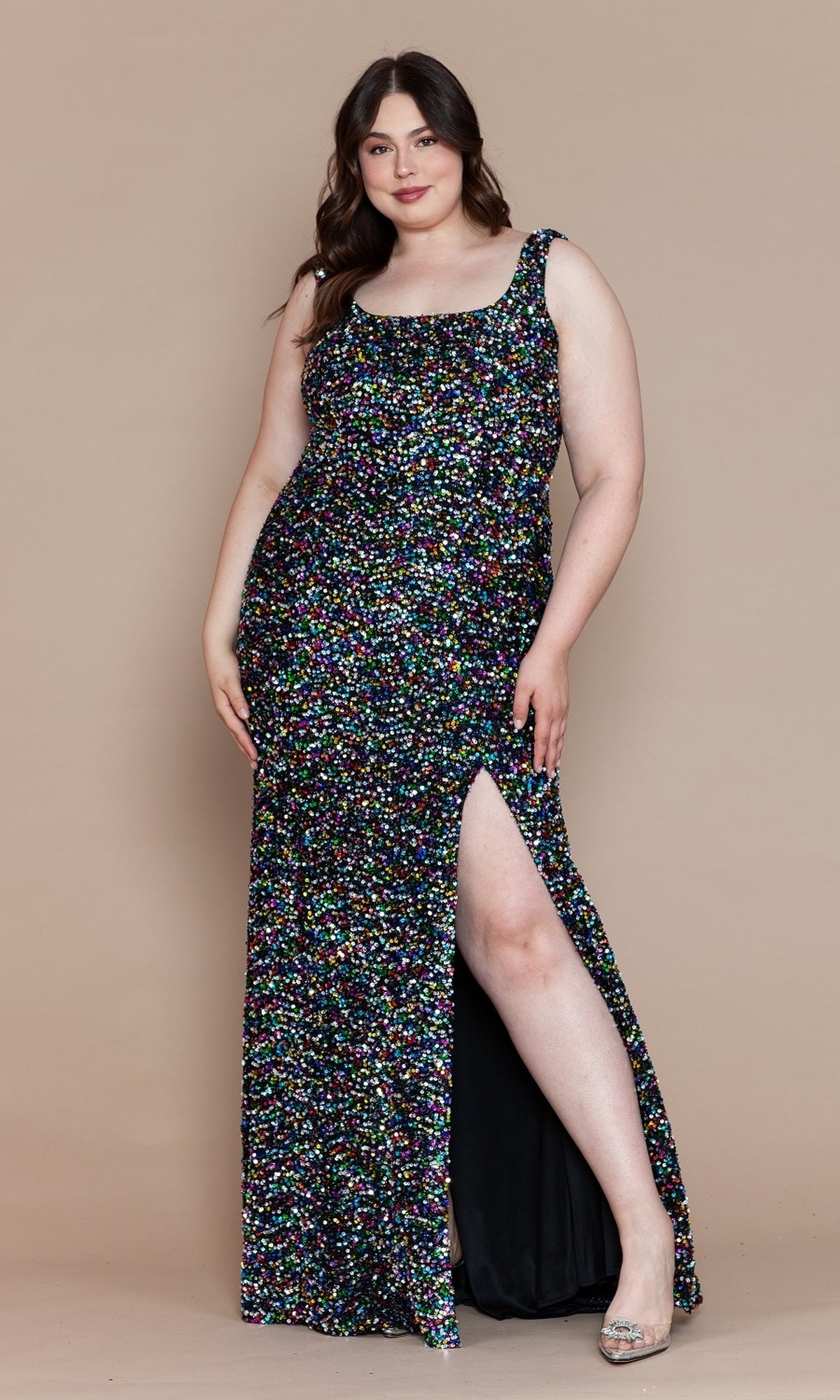 A woman models the Plus-Size Sleeveless Long Sequin Prom Dress W1126, a floor-length, elegant black dress with sequins and a thigh-high slit, posing against a plain beige background.